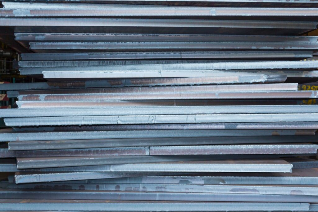 A stack of thick metal plates for use in construction projects.