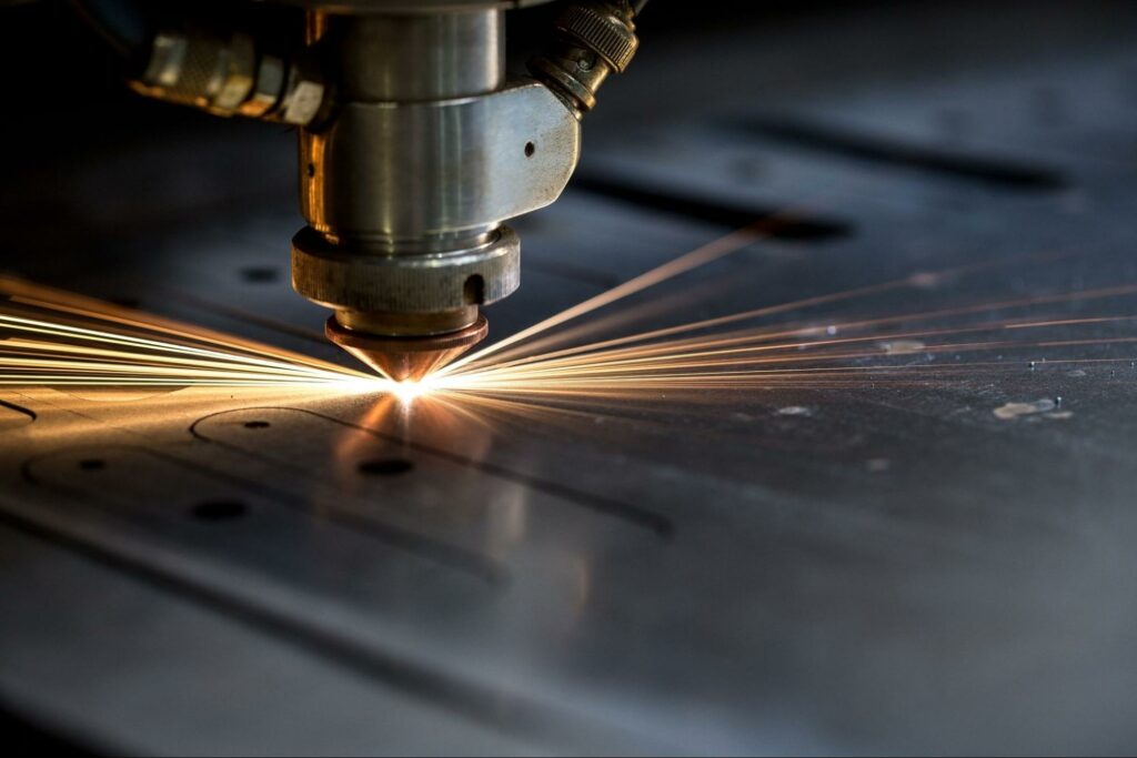 A laser cutting machine cuts through a metal plate.